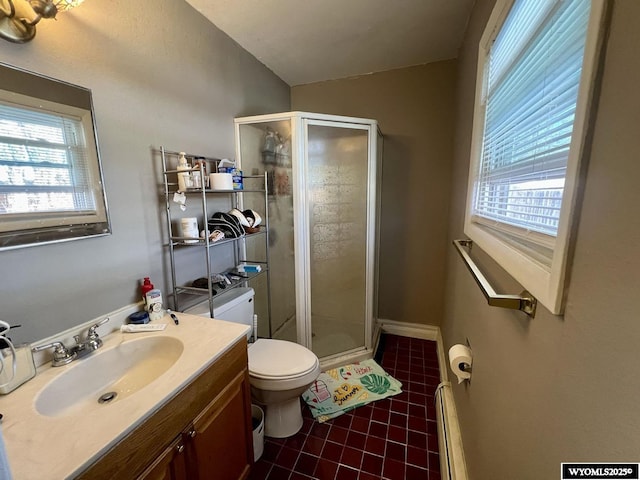 bathroom with toilet, a baseboard heating unit, vanity, tile patterned floors, and a stall shower