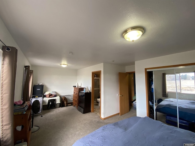 bedroom featuring baseboards, ensuite bath, and light colored carpet