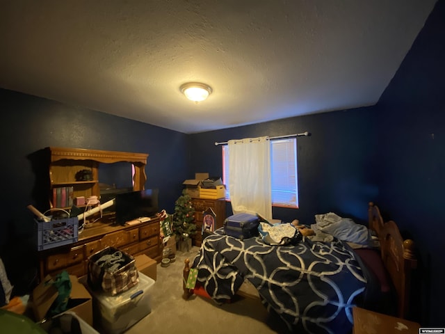 bedroom with carpet and a textured ceiling