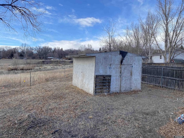 view of shed featuring fence