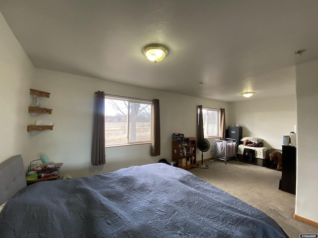 bedroom featuring baseboards and light colored carpet