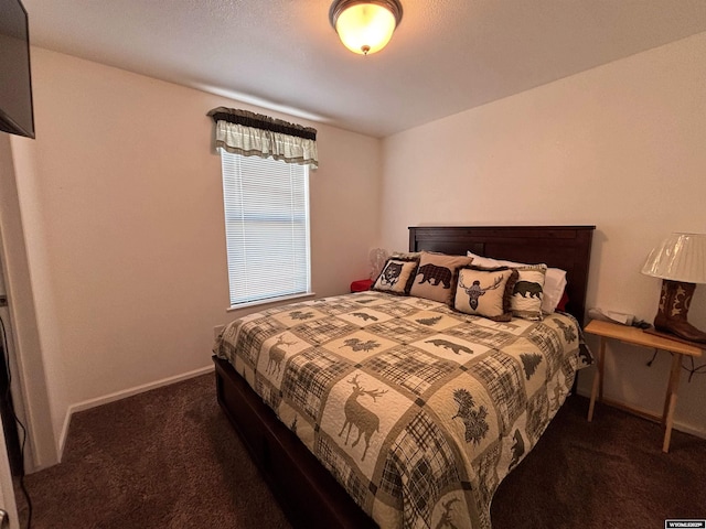 carpeted bedroom featuring baseboards