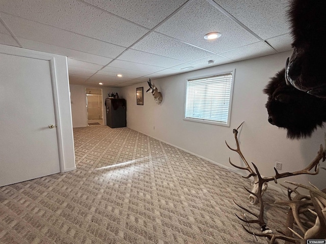 basement with carpet, a paneled ceiling, baseboards, and recessed lighting