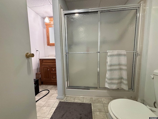 full bathroom featuring a stall shower, tile patterned flooring, vanity, and toilet