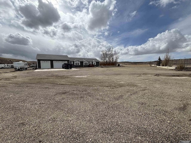 view of yard featuring driveway and an attached garage