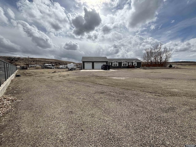 exterior space featuring a garage, driveway, and fence