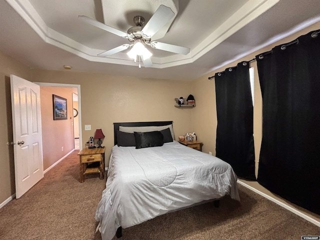 bedroom featuring carpet, a raised ceiling, a ceiling fan, and baseboards