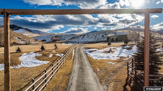 view of road with driveway and a mountain view