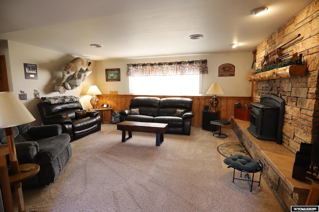 carpeted living area featuring a wainscoted wall and visible vents