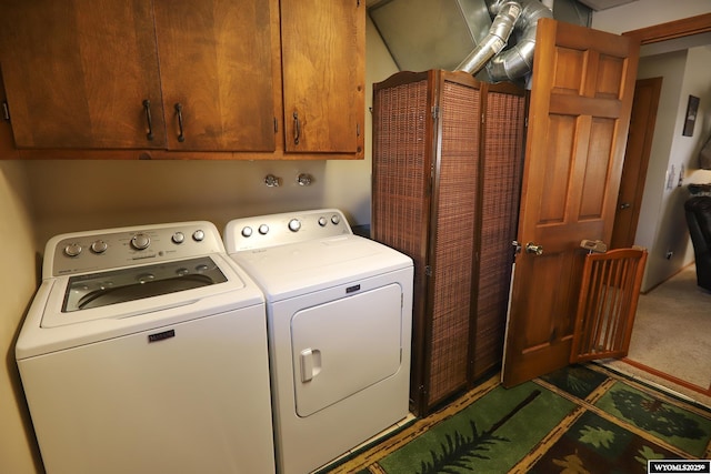 washroom with washer and clothes dryer and cabinet space