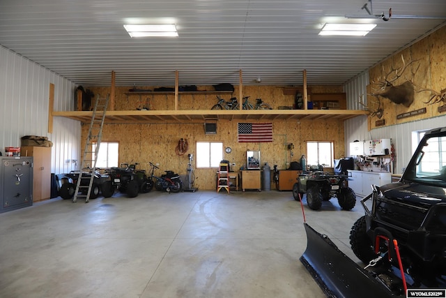 garage with a workshop area and metal wall