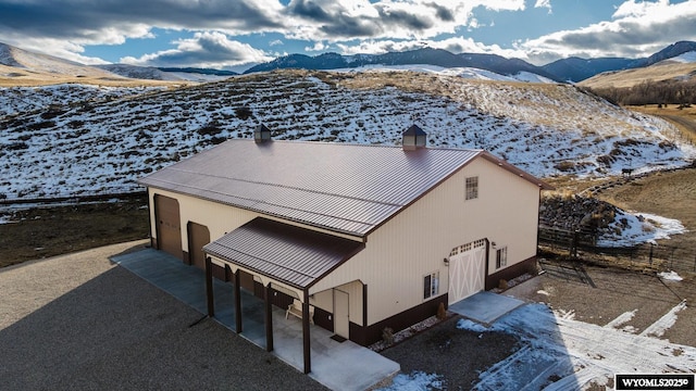 snowy aerial view with a mountain view