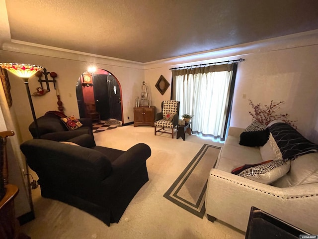 living room with arched walkways, a textured ceiling, and carpet