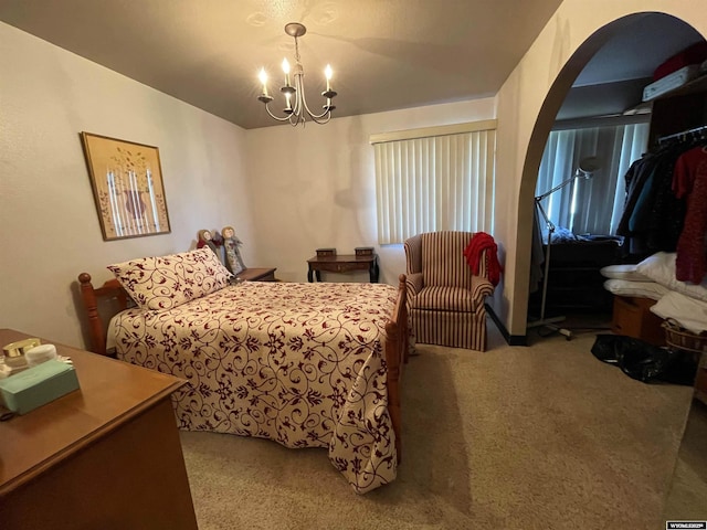 bedroom with arched walkways, light colored carpet, and an inviting chandelier