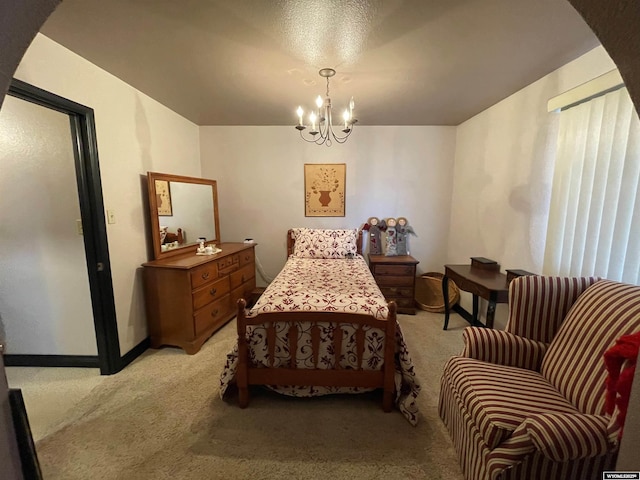 bedroom featuring baseboards, a chandelier, and light colored carpet