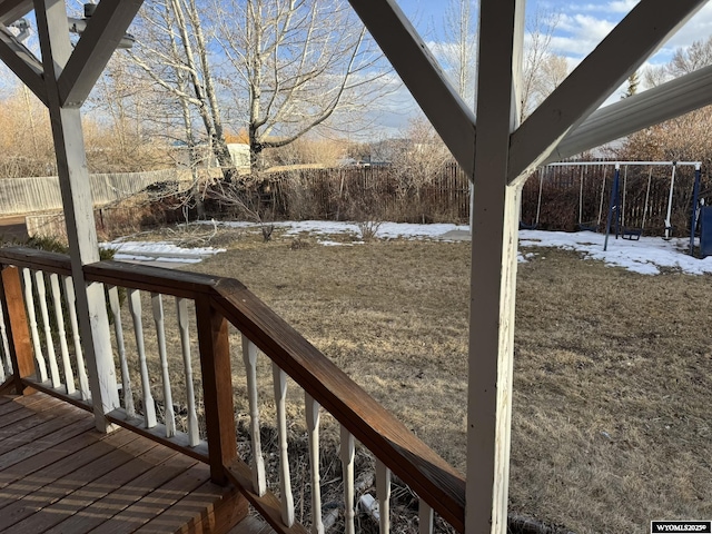 snow covered deck featuring fence