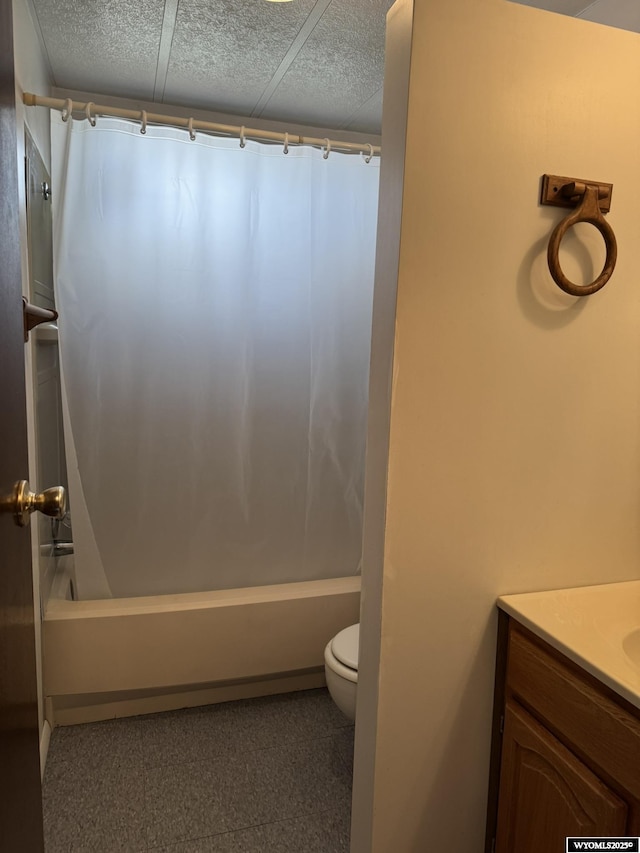 full bathroom with a textured ceiling, toilet, shower / bath combo with shower curtain, and vanity