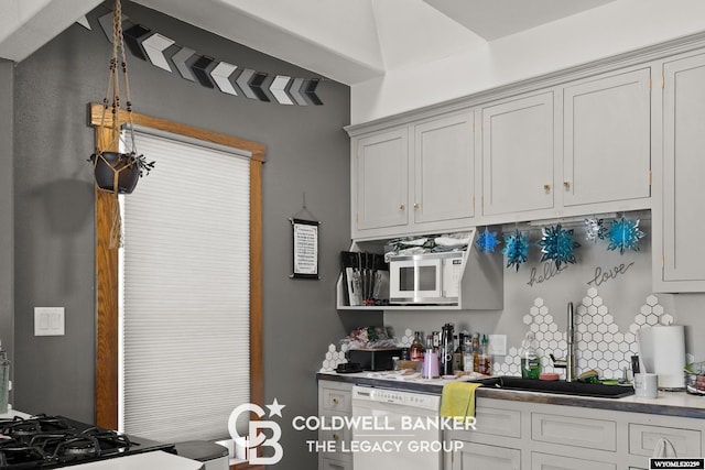 kitchen with white appliances and a sink