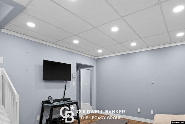 living room with a paneled ceiling and recessed lighting