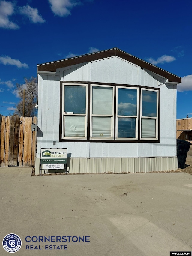 view of side of home featuring fence