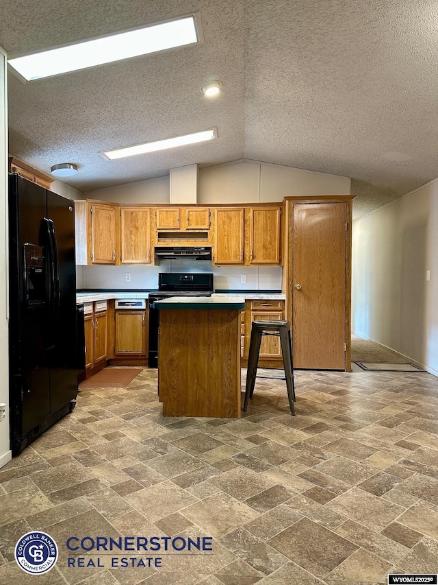 kitchen featuring black appliances, a kitchen island, light countertops, and brown cabinets