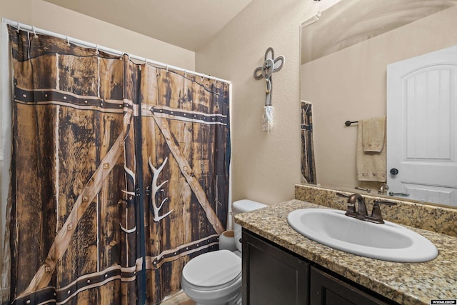 full bath with a shower with shower curtain, a textured wall, vanity, and toilet