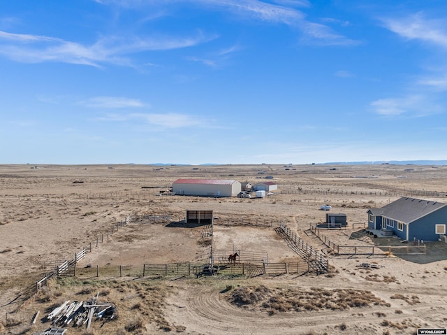 birds eye view of property featuring view of desert and a rural view