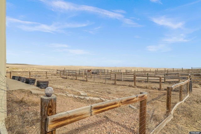 view of yard with a rural view and fence