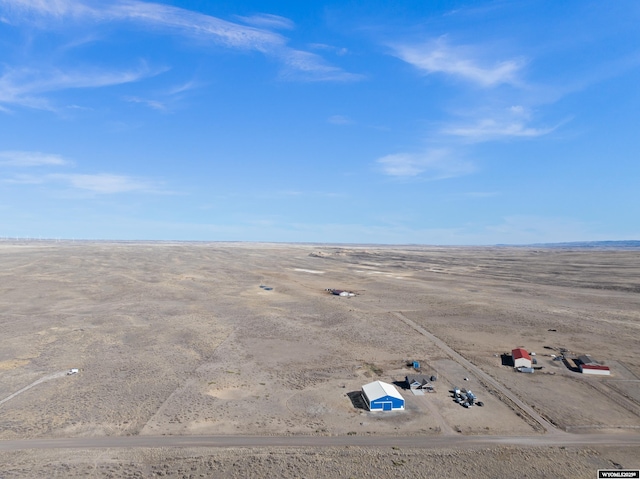 bird's eye view with view of desert and a rural view