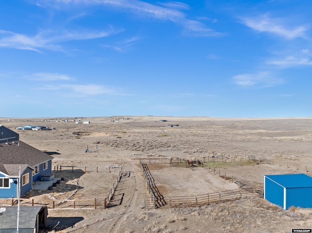 exterior space with fence and view of desert