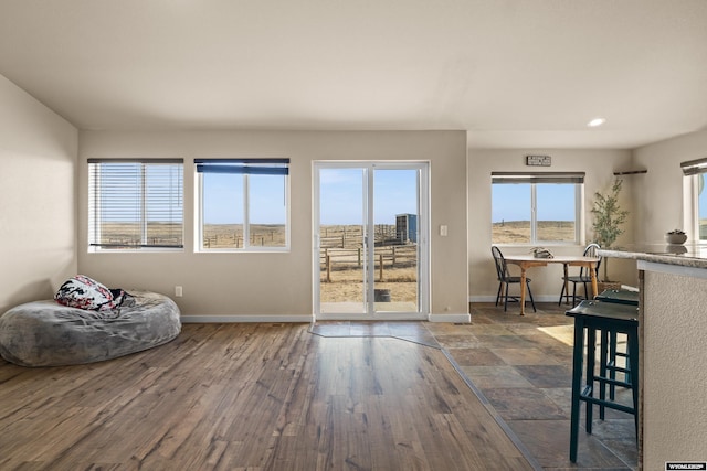 interior space with recessed lighting, baseboards, and wood finished floors