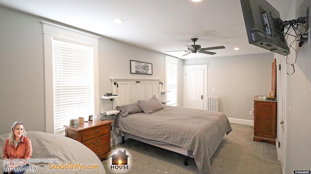 bedroom featuring recessed lighting, light carpet, baseboards, multiple windows, and radiator