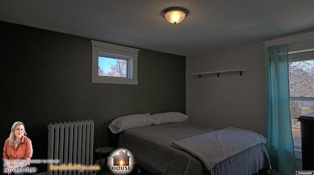 bedroom with radiator and multiple windows