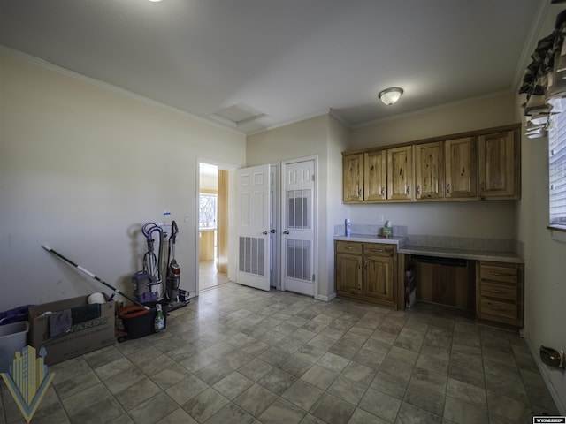 kitchen featuring brown cabinetry, light countertops, and crown molding