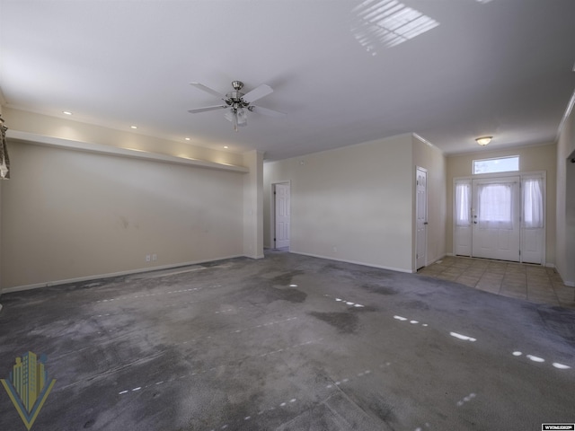 unfurnished room with ceiling fan and baseboards