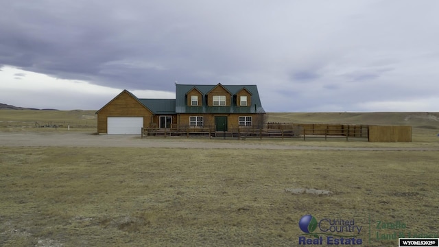 1596 Rd 109, Cheyenne, WY 82009 - view of front of home with a rural view, metal roof, fence, a front lawn, and a garage