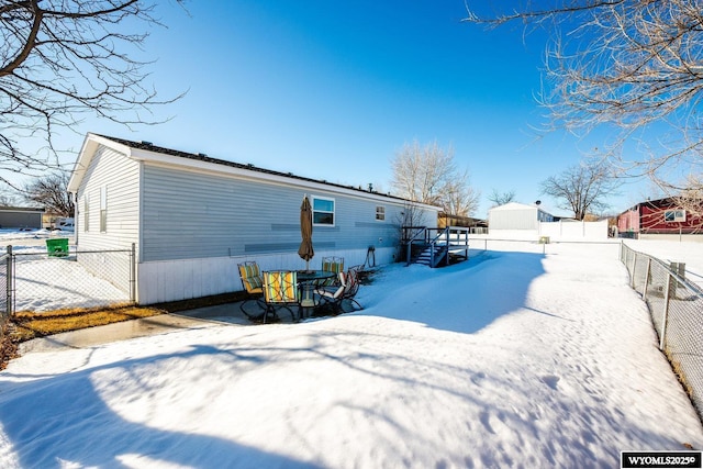 snow covered property featuring fence private yard