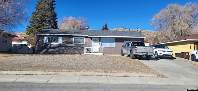 single story home featuring driveway and fence