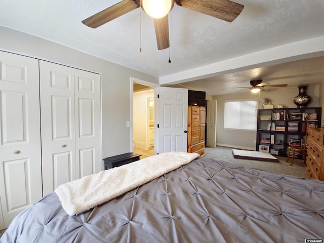 carpeted bedroom with ceiling fan, a closet, and baseboards