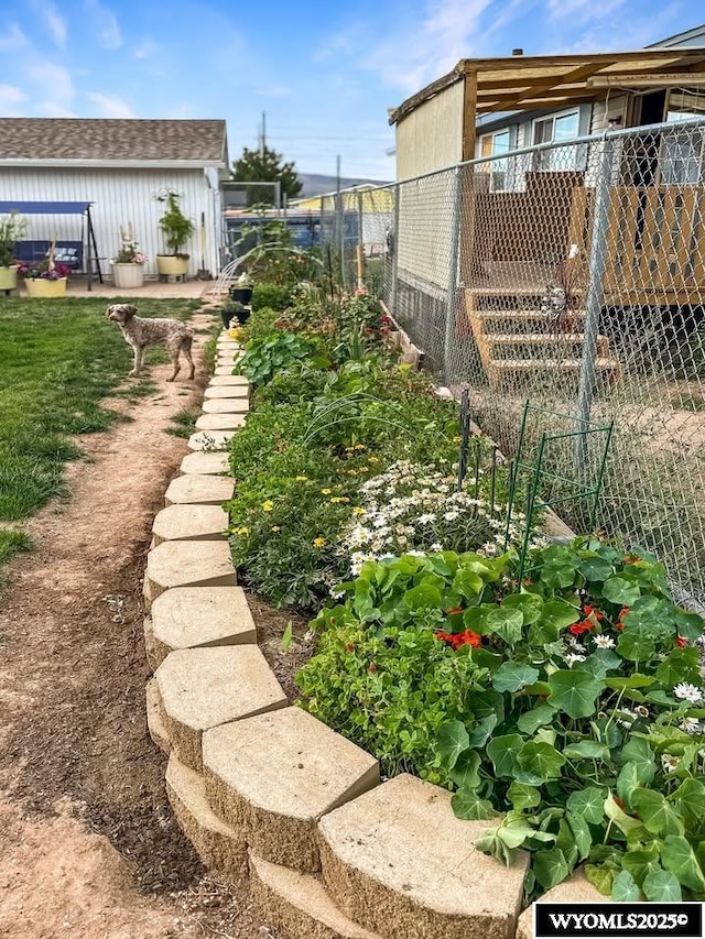 view of yard featuring an outbuilding and fence