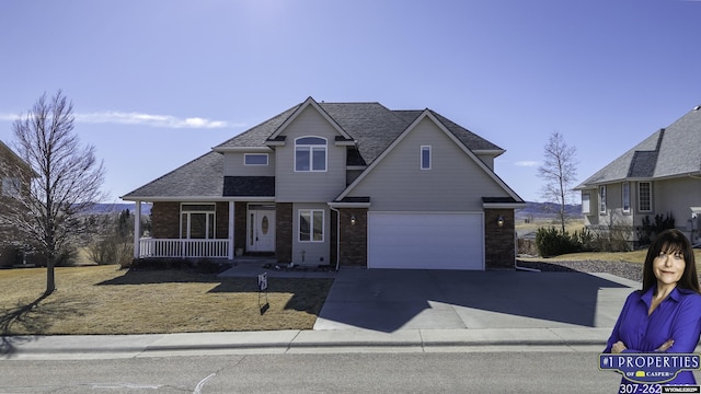 view of front of house with a garage, a shingled roof, concrete driveway, covered porch, and a front yard