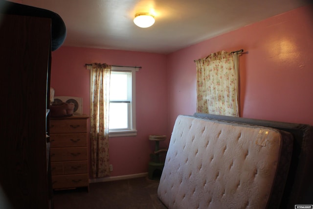 bedroom featuring carpet and baseboards