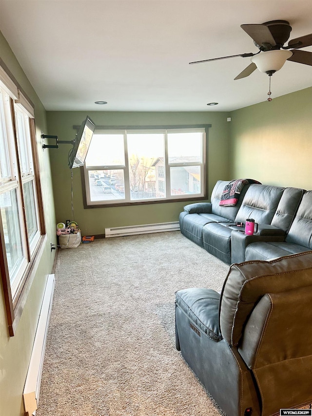 living area with ceiling fan, a baseboard radiator, and carpet flooring