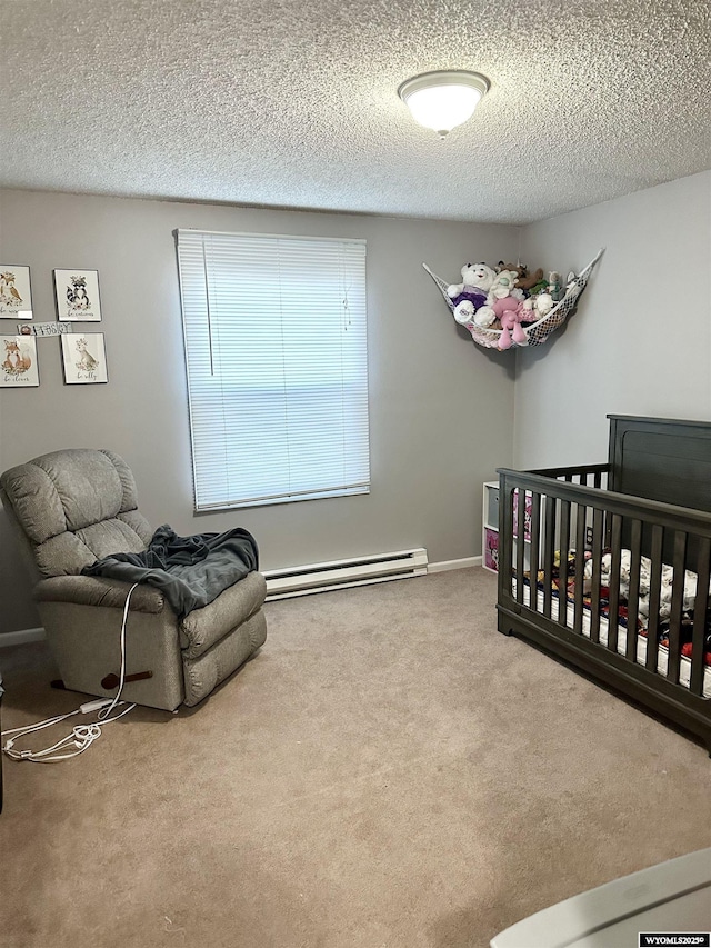 carpeted bedroom featuring baseboard heating and a textured ceiling