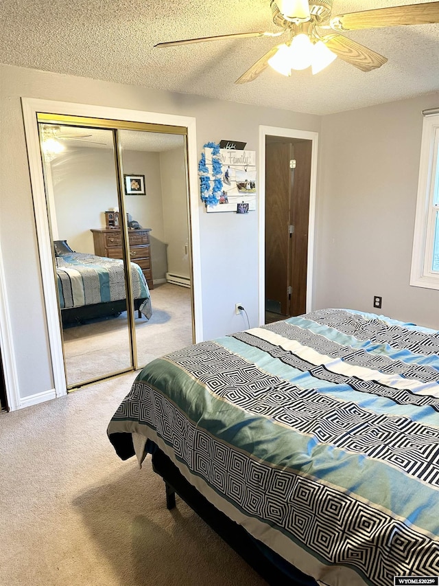 carpeted bedroom with baseboards, a ceiling fan, a textured ceiling, a baseboard heating unit, and a closet