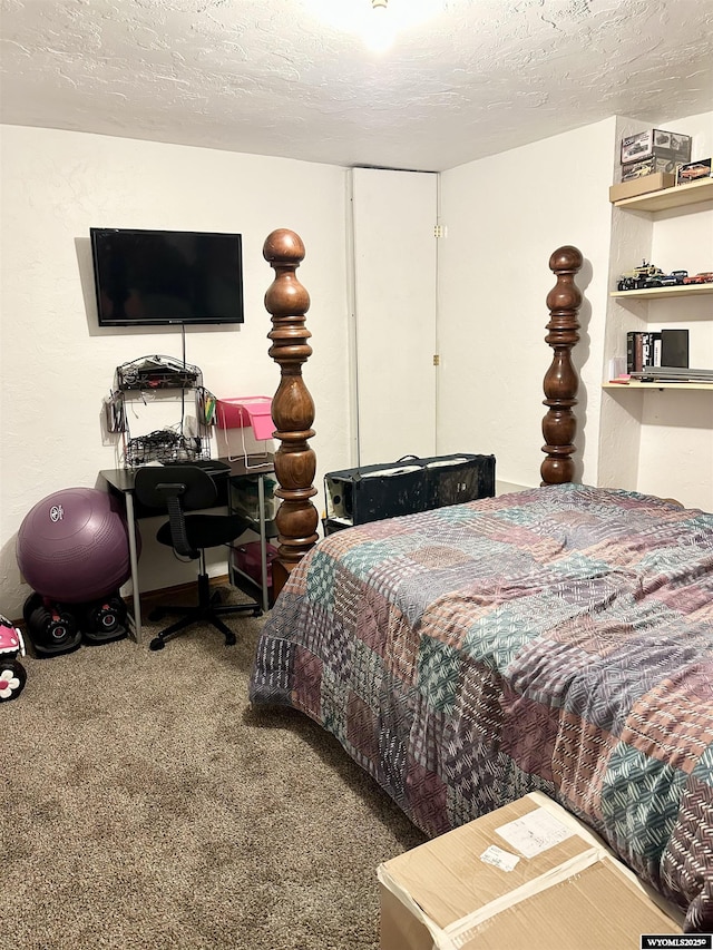 bedroom featuring carpet floors and a textured ceiling