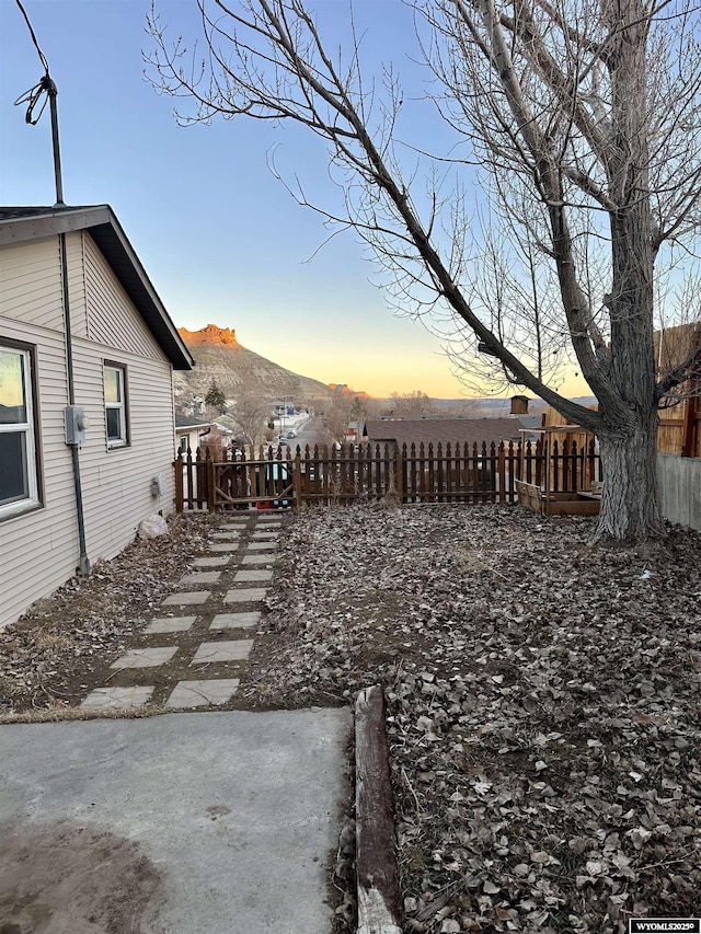 view of yard featuring fence and a mountain view