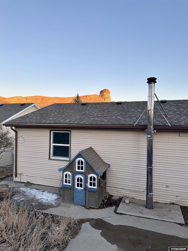 back of property featuring a shingled roof