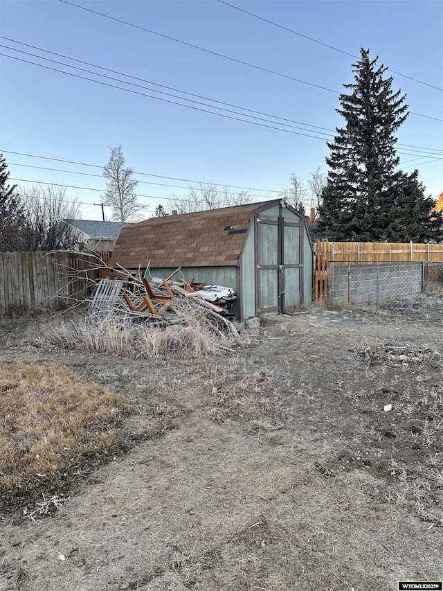 view of shed with fence