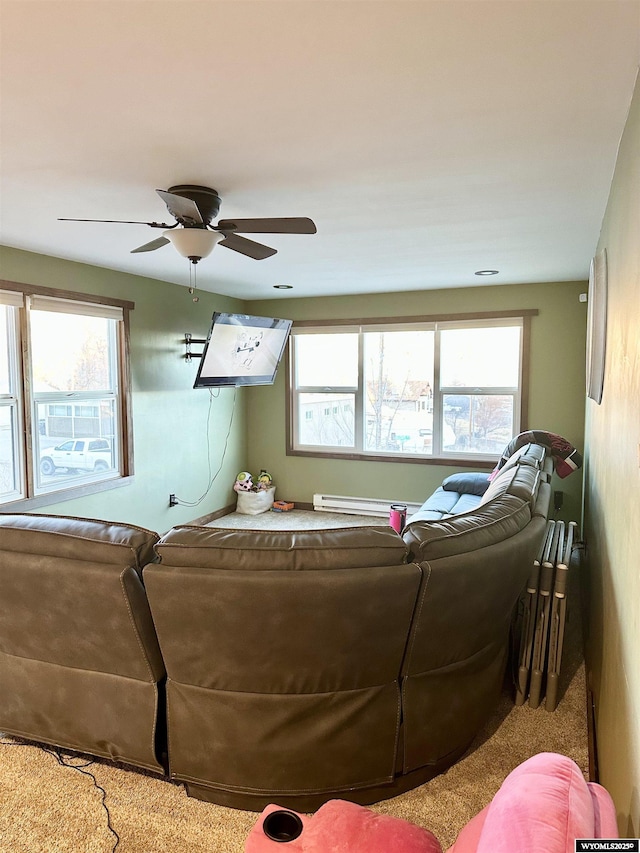 living room featuring a baseboard heating unit and ceiling fan